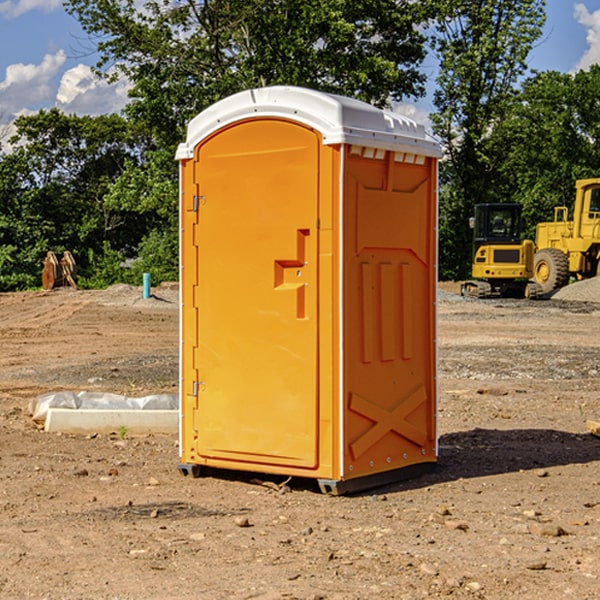 what is the cost difference between standard and deluxe portable restroom rentals in Columbus Junction